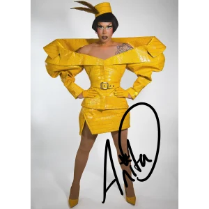 Signed Anita Piss print, a photograph of Anita in her saffron croc 'Meet the Queens' look with her signature in black