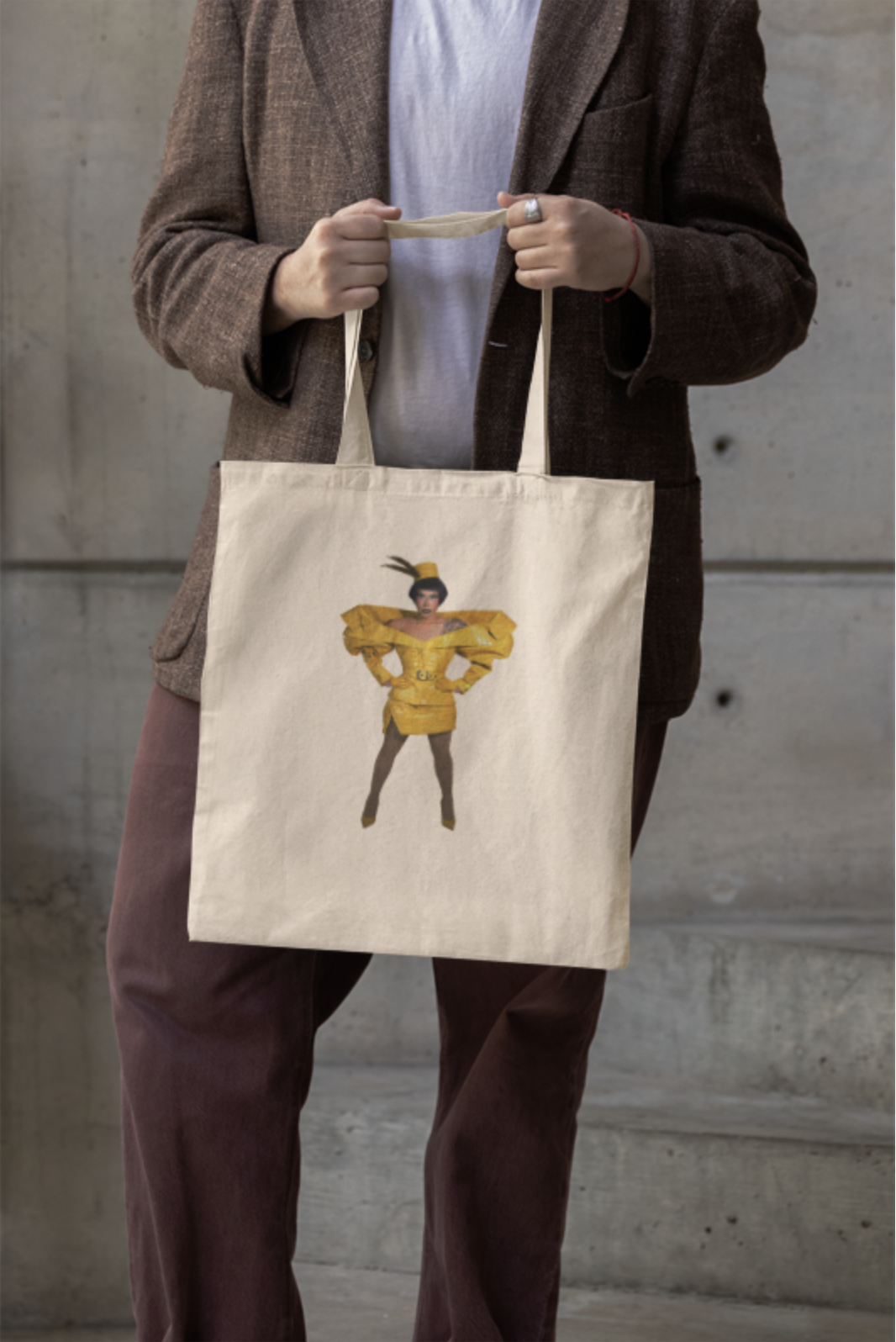 Person carrying a natural cotton Anita Piss tote bag printed with Anita in her saffron croc look